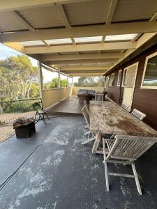 a patio with a table and chairs on a house at Sun, Sand, and Tranquility in Rye in Rye