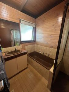 a bathroom with a bath tub and a sink at Sun, Sand, and Tranquility in Rye in Rye