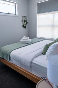 a bedroom with a large bed with a window at Home Abroad in Ascot Park +68 photos