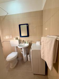 a bathroom with a white toilet and a sink at B&B Marku in Dëllinjë +29 photos