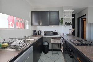 a kitchen with a sink and a counter at Blouberg Beach Escape in Cape Town