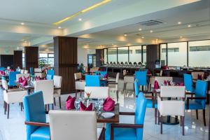 a restaurant with blue and white chairs and tables at Avari Xpress Gilgit in Gilgit +42 photos