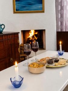 a table with a plate of food and two glasses of wine at Eucalyptus Cottage in Cape Town