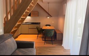 a living room with a table and chairs and a kitchen at Riolina Suite in Mühlbach +8 photos