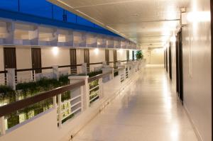 an empty hallway of a building with plants at Kasemsarn Hotel Chanthaburi in Chanthaburi