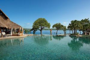 a swimming pool with a view of the water at Secrets Papagayo All Inclusive - Adults Only in Culebra