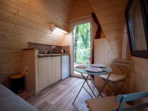 a room with a table and chairs in a cabin at La cabane en A 