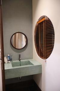 a bathroom with a sink and a mirror at Shine Home in Hue