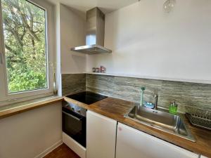 a kitchen with a sink and a window at Sea Breeze - Barcola - Trieste Reception in Trieste