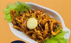 a white bowl of food with lettuce and shrimp at Nilaveli Eco Lodge in Nilaveli +24 photos