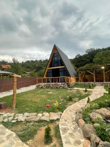 a large wooden house with a gambrel roof at Hayrapet Asatryan in Arzakan