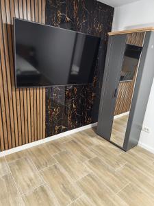a flat screen tv on a wall in a living room at Terra Residence Beiuș in Beiuş
