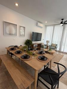 a large wooden table with chairs in a living room at Bajareque Oceanfront Luxury 3 BR Villa in Telchac Puerto