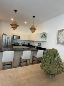 a kitchen with white cabinets and a table and chairs at Bajareque Oceanfront Luxury 3 BR Villa in Telchac Puerto