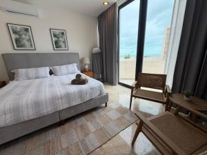 a bedroom with a bed with a teddy bear on it at Bajareque Oceanfront Luxury 3 BR Villa in Telchac Puerto