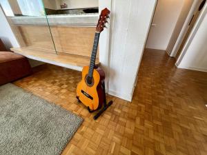 a guitar is leaning up against a wall at Sea Breeze - Barcola - Trieste Reception in Trieste