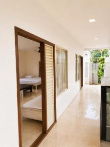 a hallway with a door leading to a bedroom at Vedic villa Cherai beach in Cochin