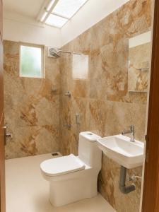 a bathroom with a toilet and a sink at Vedic villa Cherai beach in Cochin