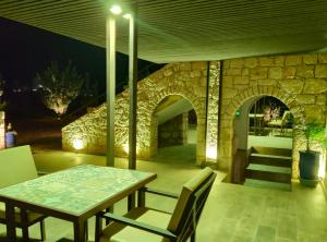 a dining room with a table and a stone fireplace at Villa A'Kabar Guest House in Aït Benhaddou +87 photos