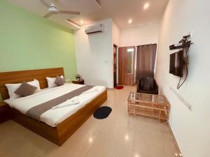 a bedroom with a bed and a chair in it at Sea Mist Beach Villas Alleppey in Alleppey