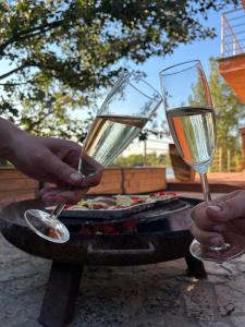 two people are holding champagne glasses on a table at Sentio Inn 2 in Dunajská Streda