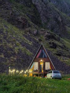 a house with a car parked in front of it at Gudika • გუდიკა in Sno
