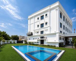 a building with a swimming pool in front of a building at The Four Seasons Recreation in Jālgaon