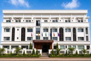 a white building with flags in front of it at The Four Seasons Recreation in Jālgaon