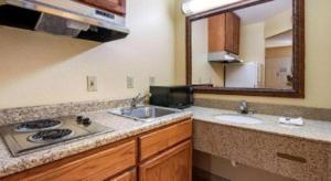 a bathroom with two sinks and a mirror at Rodeway Inn & Suites in Lakeview +65 photos
