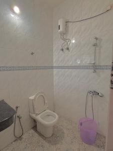 a bathroom with a toilet and a shower in it at Tvm stays in Trivandrum
