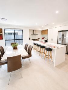 a kitchen and dining room with a table and chairs at 4 Bedrooms Home in Gledswood Hills