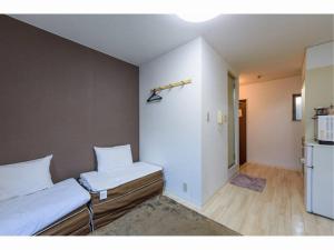 a small bedroom with two beds and a refrigerator at Private House Sora / Vacation STAY 1122 in Sakai +18 photos