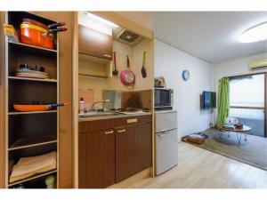 a small kitchen with a sink and a stove at Private House Sora / Vacation STAY 1122 in Sakai