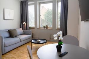 a living room with a couch and a table at Biz Apartment Solna in Solna