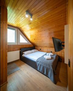 a bedroom with a bed in a wooden cabin at Casa Edy in Sovata +58 photos