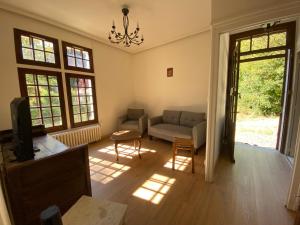 a living room with a couch and a table at Domaine Lainault - Logement des Vignerons in Lhomme