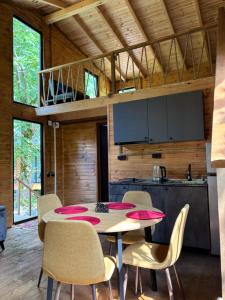 a kitchen and dining room with a table and chairs at Babitouli-3 in Niabauri