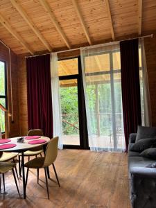 a living room with a table and a couch at Babitouli-3 in Niabauri +28 photos