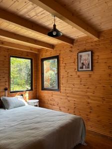 a bedroom with a bed in a wooden room at Babitouli-3 in Niabauri