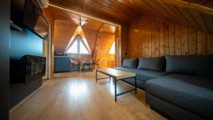 a living room with a couch and a table at Casa Edy in Sovata