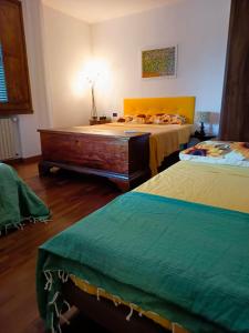 a bedroom with a large bed with a wooden bed frame at Bed and Breakfast La Contessa in Santo Stefano