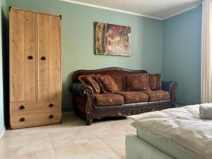 a living room with a couch and a cabinet at R Limoli Cozy in Trávnica