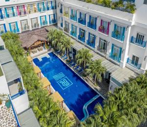 an aerial view of a hotel with a pool and palm trees at Risemount Premier Resort Da Nang in Danang +42 photos