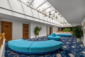 a large room with a large blue bed in the middle at Risemount Premier Resort Da Nang in Danang