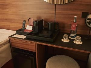 a desk with a coffee maker and a bottle of wine at Carlton Boutique Hotel - NEW OPENING in Vienna