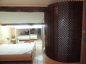 a bedroom with a bed and a living room at Chambres GAMBETTA in Béziers