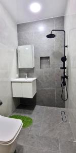 a bathroom with a shower and a sink and a toilet at Maftun Guest House in Samarkand