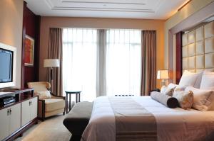 Postel nebo postele na pokoji v ubytování Xijiao State Guest Hotel