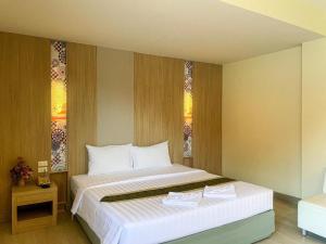 a bedroom with a large bed in a room at Bunjongburi Hotel in Ban Tha Kup +64 photos