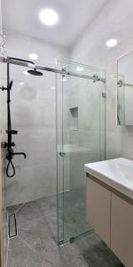 a bathroom with a glass shower and a sink at Maftun Guest House in Samarkand +41 photos